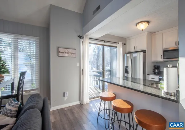 a kitchen with stainless steel appliances a refrigerator stove and microwave