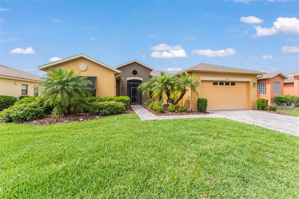 724 Villa Park Road Poinciana, FL 34759 - Photo 1 of 62 a front view of a house with garden