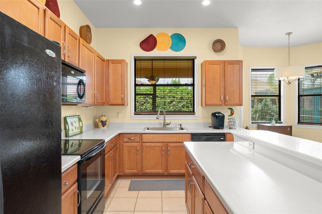 724 Villa Park Road Poinciana, FL 34759 - Photo 11 of 62 a kitchen with a sink a stove and a refrigerator