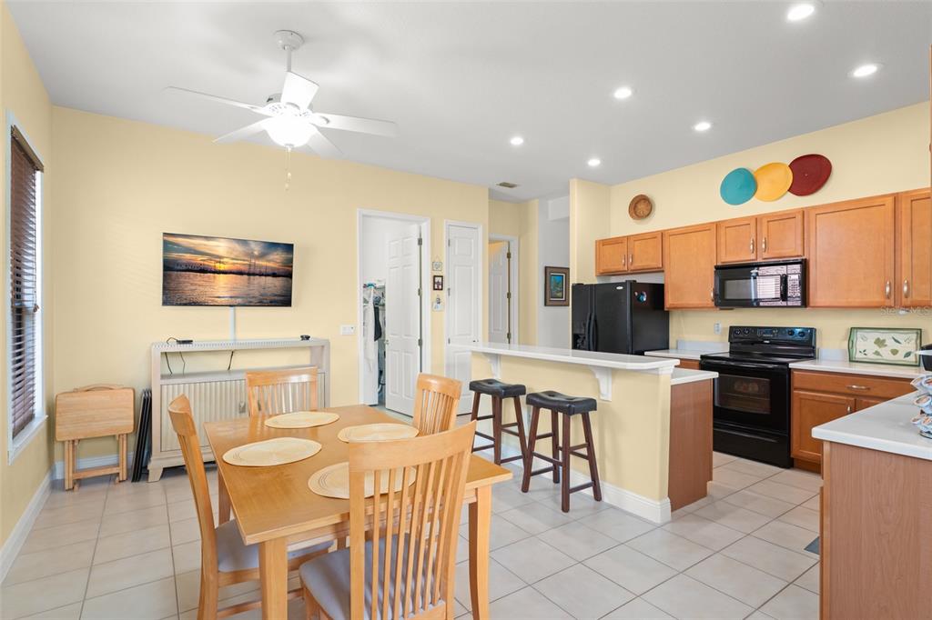 724 Villa Park Road Poinciana, FL 34759 - Photo 14 of 62 a kitchen with stainless steel appliances kitchen island granite countertop a sink and cabinets