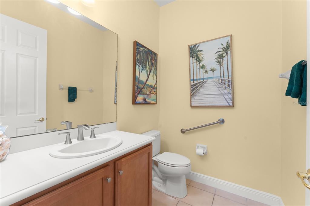 724 Villa Park Road Poinciana, FL 34759 - Photo 15 of 62 a bathroom with a toilet a sink and mirror