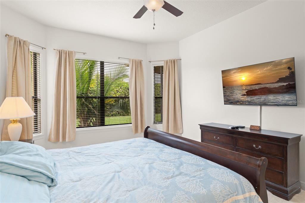 724 Villa Park Road Poinciana, FL 34759 - Photo 19 of 62 a bedroom with a bed and a flat screen tv