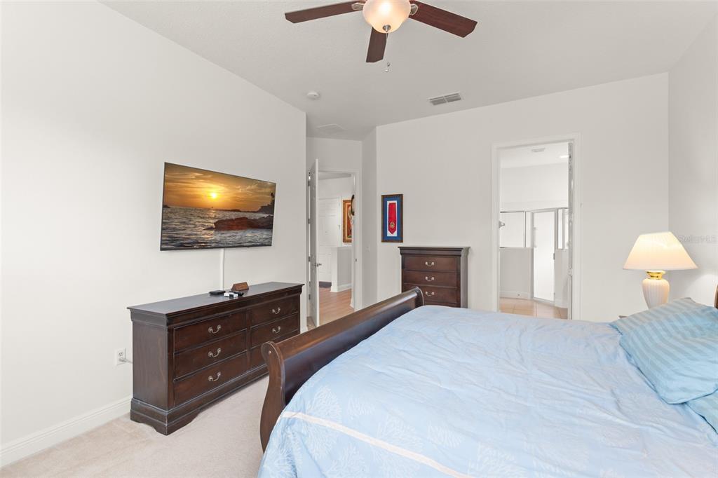 724 Villa Park Road Poinciana, FL 34759 - Photo 20 of 62 a bedroom with a bed and a flat screen tv