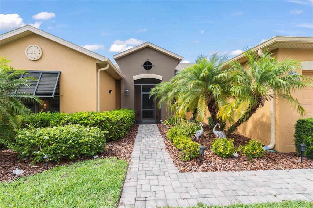 724 Villa Park Road Poinciana, FL 34759 - Photo 2 of 62 a front view of a house with garden