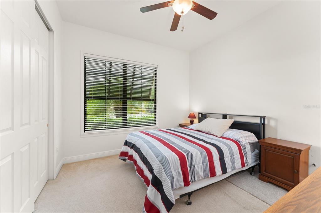 724 Villa Park Road Poinciana, FL 34759 - Photo 24 of 62 a bed sitting in a bedroom next to a window