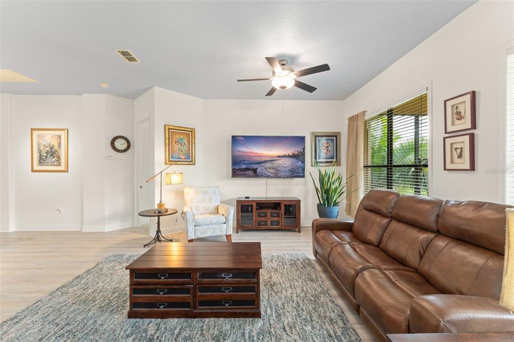 724 Villa Park Road Poinciana, FL 34759 - Photo 4 of 62 a living room with furniture a fireplace and a flat screen tv