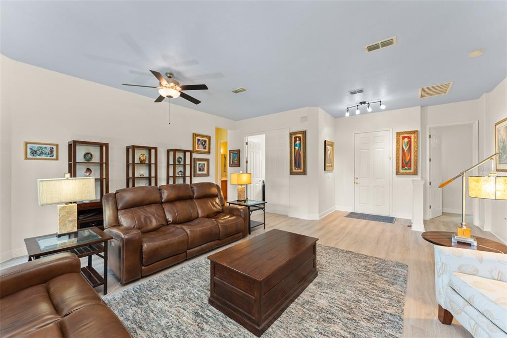 724 Villa Park Road Poinciana, FL 34759 - Photo 6 of 62 a living room with furniture and a chandelier