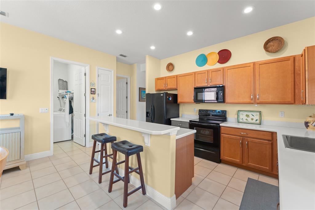 724 Villa Park Road Poinciana, FL 34759 - Photo 8 of 62 a kitchen with stainless steel appliances kitchen island granite countertop a sink and cabinets