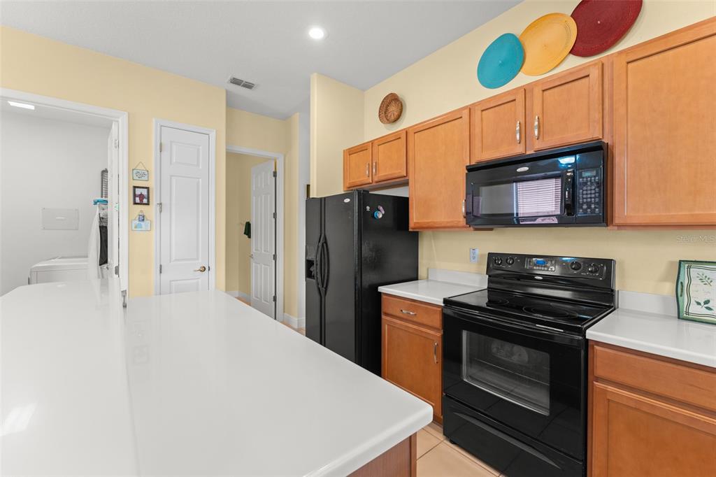 724 Villa Park Road Poinciana, FL 34759 - Photo 10 of 62 a kitchen with stainless steel appliances a stove a microwave a sink and cabinets