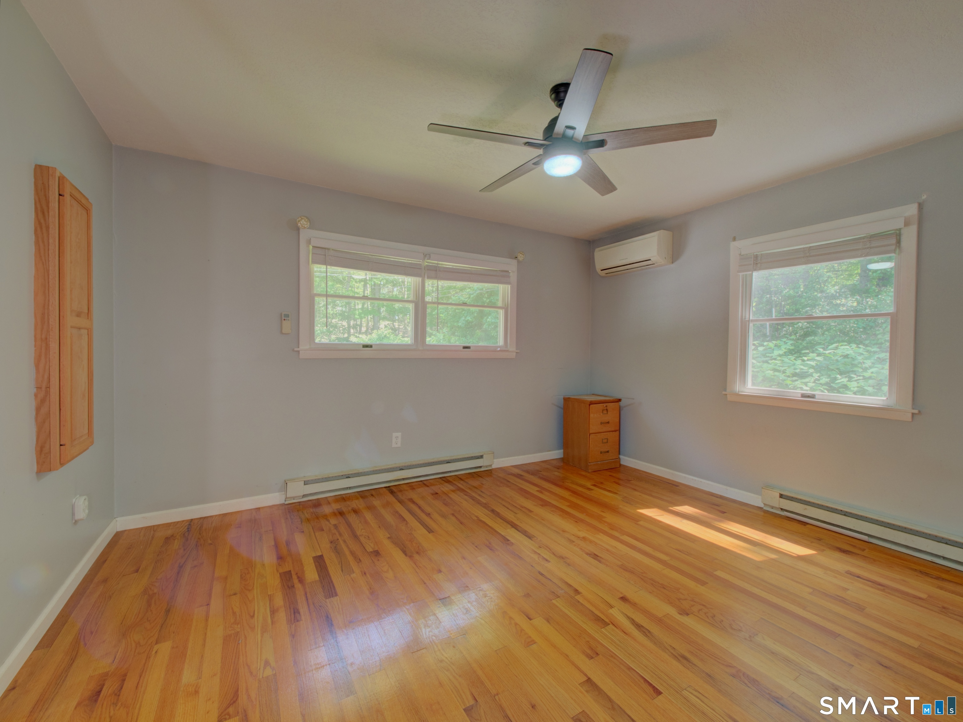 311 Sandy Hollow Road Groton, CT 06355 - Photo 7 of 26 a view of an empty room with wooden floor and a window