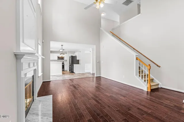 a view of a hallway with wooden floor and staircase