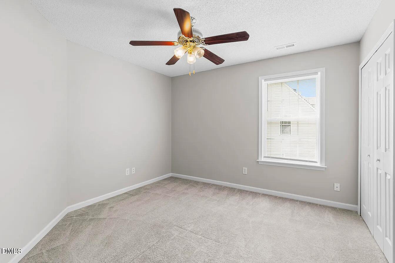 5 Gateview Court Durham, NC 27703 - Photo 19 of 23 an empty room with a window and a ceiling fan