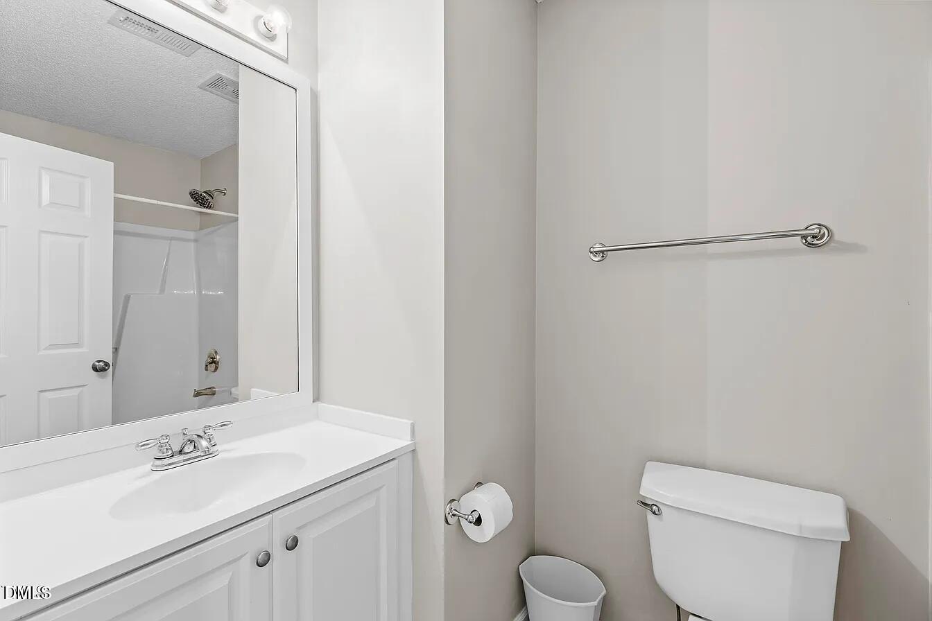 5 Gateview Court Durham, NC 27703 - Photo 20 of 23 a bathroom with a toilet sink vanity and mirror