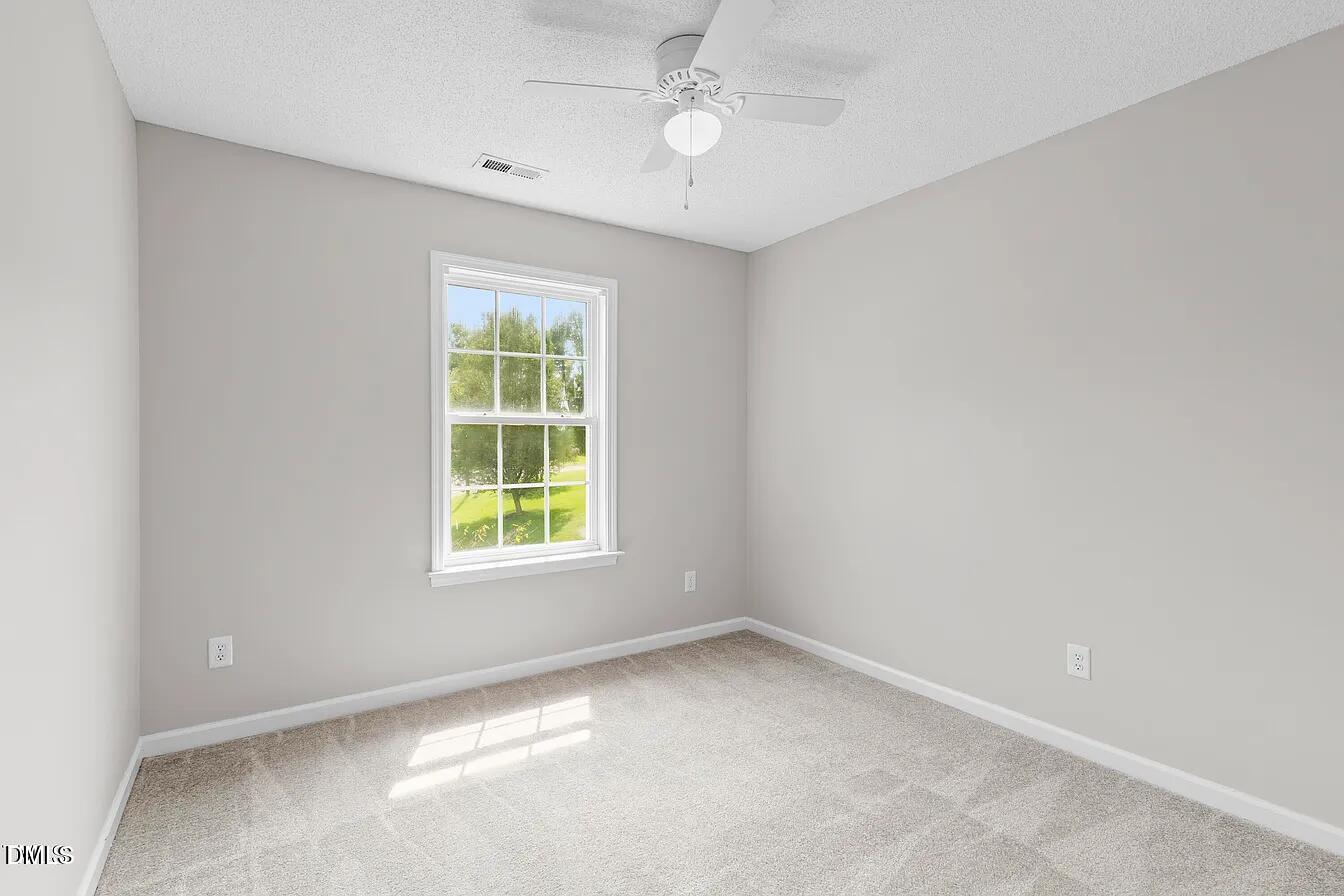 5 Gateview Court Durham, NC 27703 - Photo 21 of 23 an empty room with a window and ceiling fan