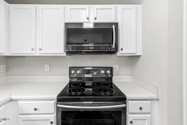 a stove top oven sitting inside of a kitchen