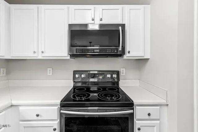 a stove top oven sitting inside of a kitchen
