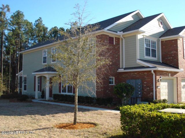 6963 Roundleaf Drive Jacksonville, FL 32258 - Photo 1 of 16 a front view of a house with garden