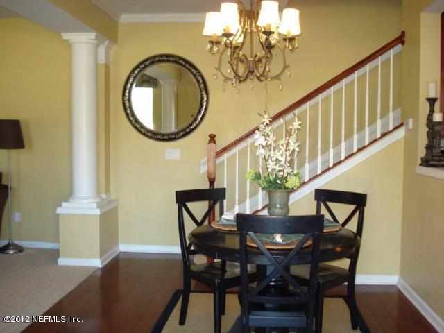 6963 Roundleaf Drive Jacksonville, FL 32258 - Photo 2 of 16 a view of a dining room with furniture and chandelier