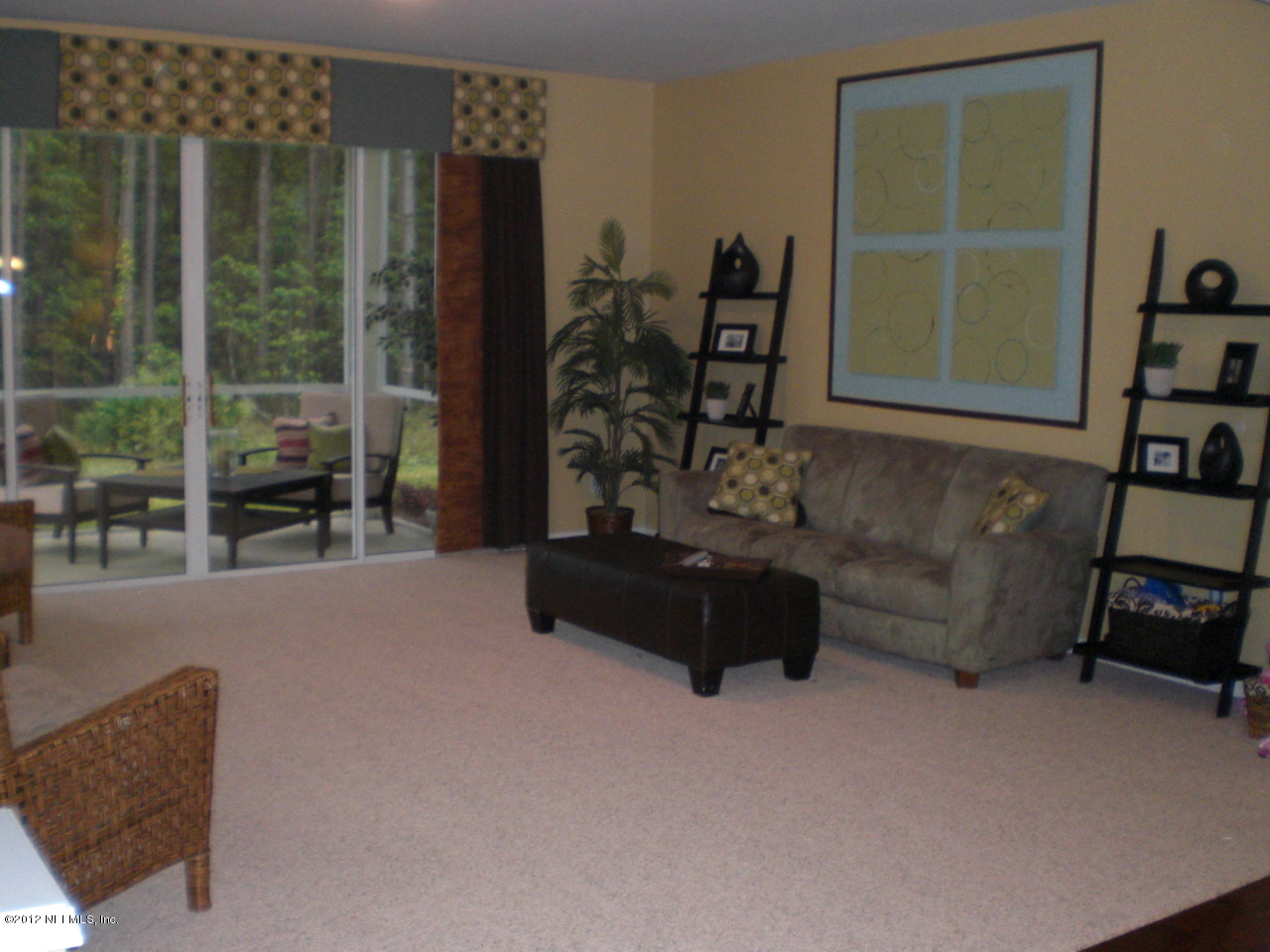 6963 Roundleaf Drive Jacksonville, FL 32258 - Photo 3 of 16 a living room with furniture and a window