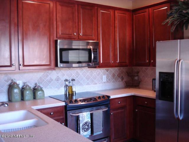 6963 Roundleaf Drive Jacksonville, FL 32258 - Photo 5 of 16 a kitchen with stainless steel appliances granite countertop a sink stove and microwave