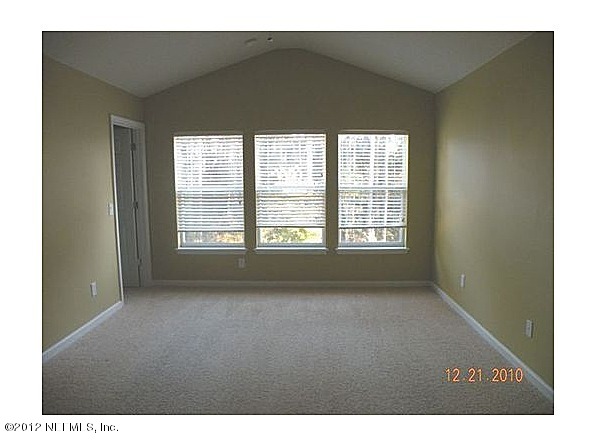 6963 Roundleaf Drive Jacksonville, FL 32258 - Photo 6 of 16 a view of a big room with windows and chandelier