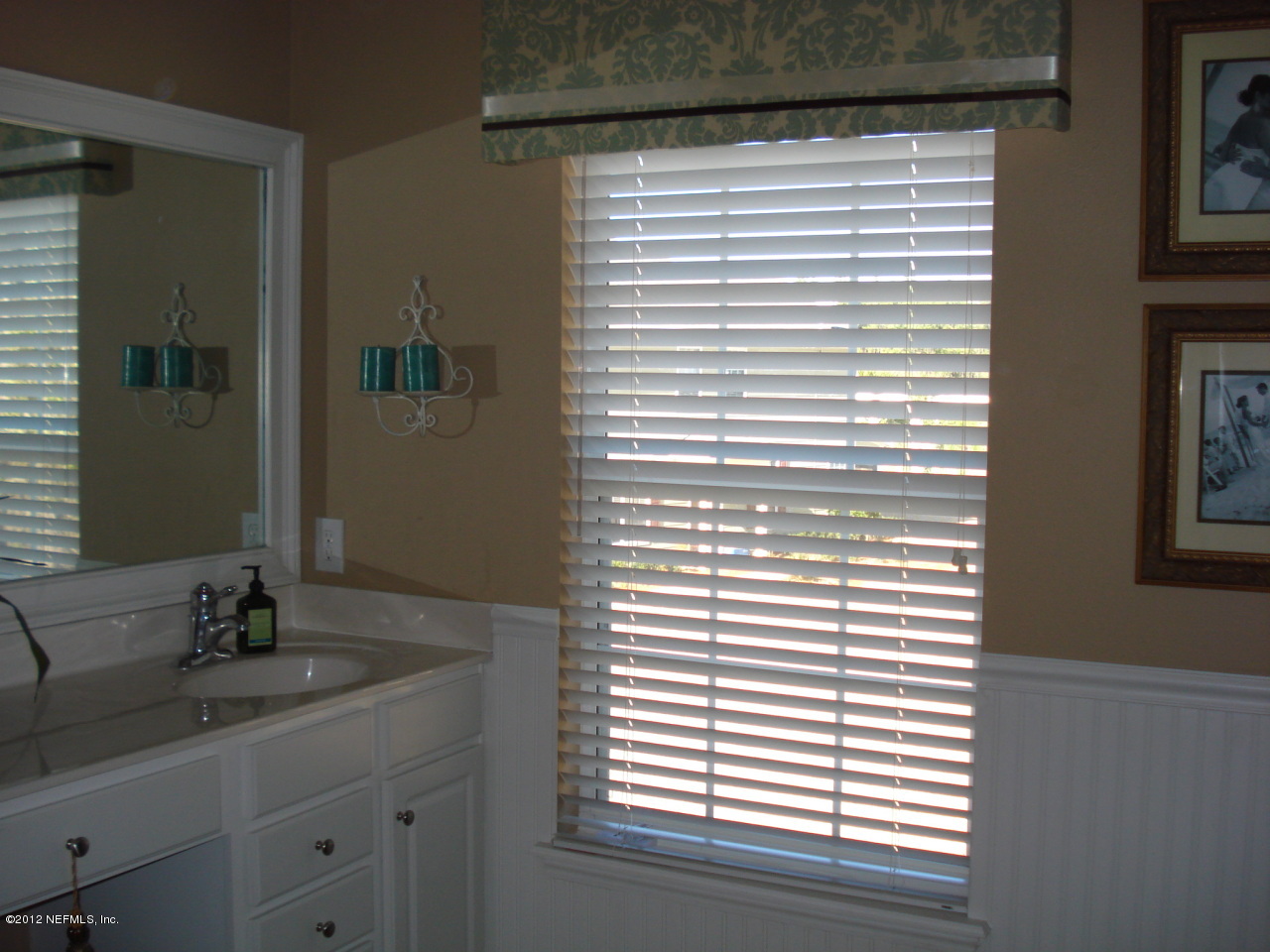 6963 Roundleaf Drive Jacksonville, FL 32258 - Photo 7 of 16 a bathroom with a sink and a mirror