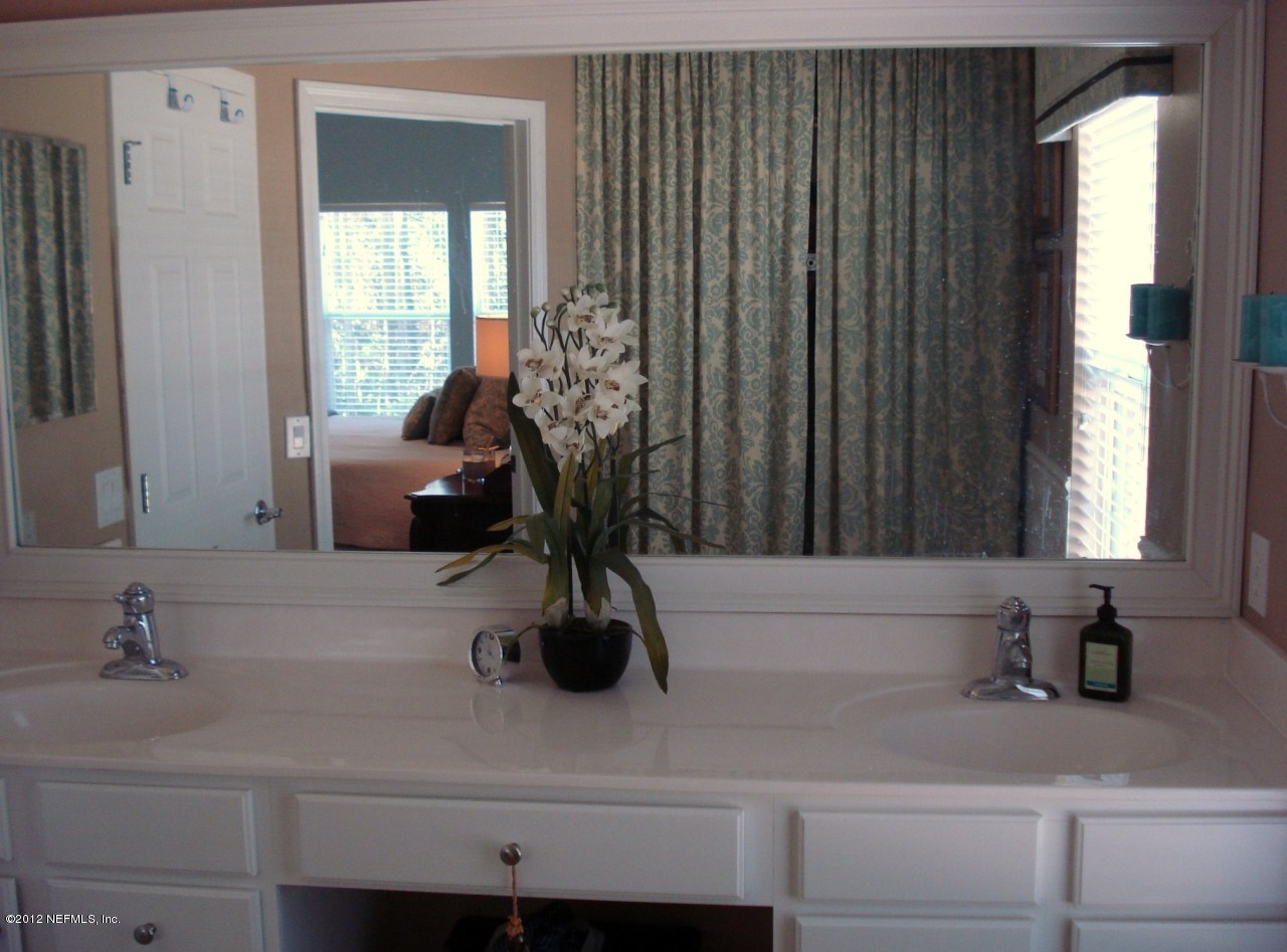 6963 Roundleaf Drive Jacksonville, FL 32258 - Photo 8 of 16 a bathroom with a sink and a mirror