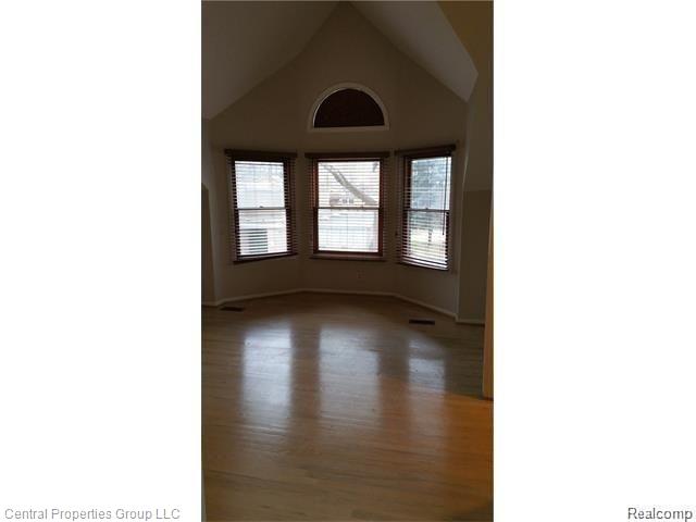 1244 Labrosse Street, Unit 2 Detroit, MI 48226 - Photo 7 of 23 Large Master Bedroom with Laminate Floors, High Ceilings, and Beautiful Window Lines