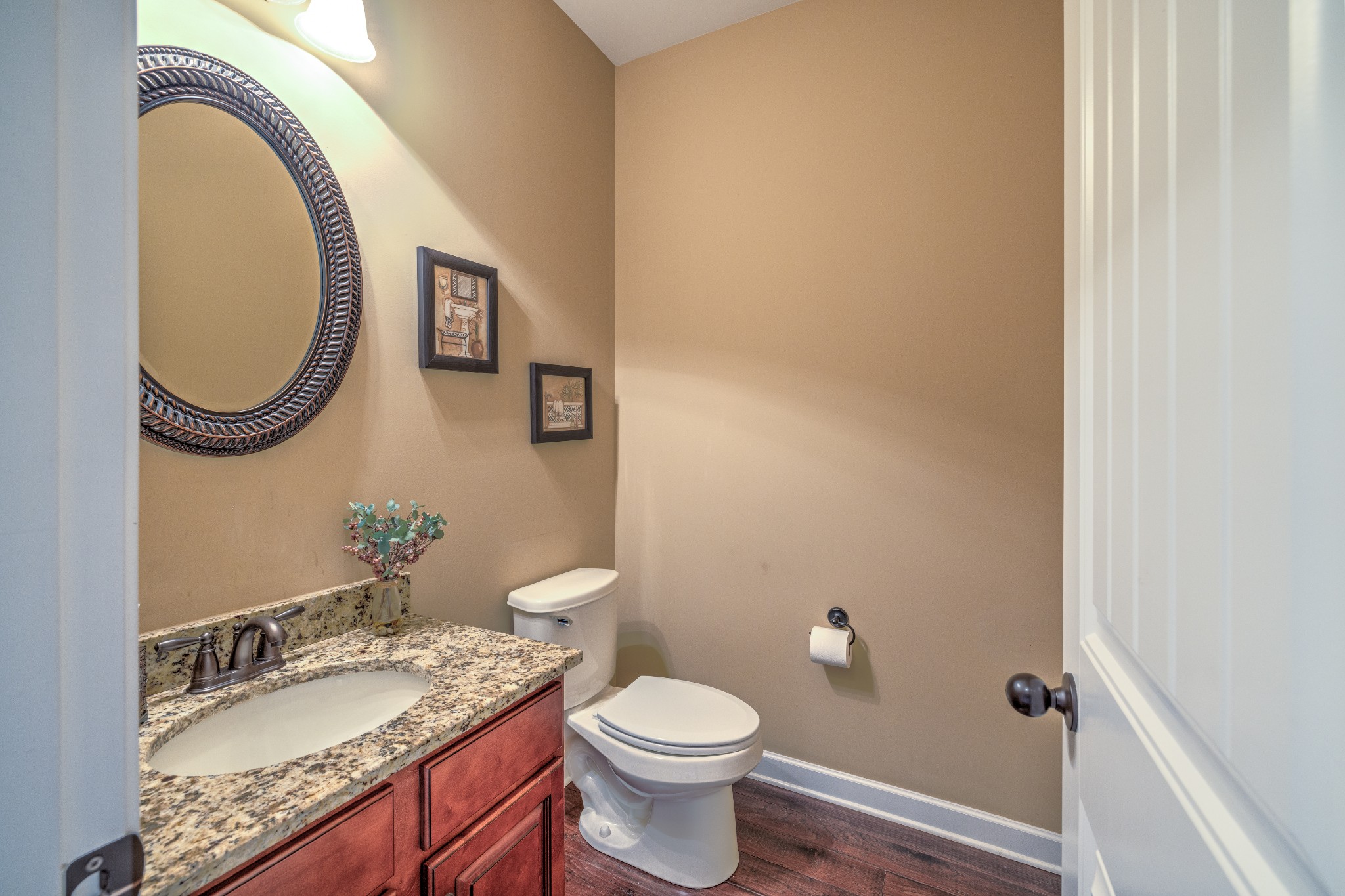 5048 Falling Water Road Nolensville, TN 37135 - Photo 7 of 40 a bathroom with a granite countertop toilet a sink and a mirror