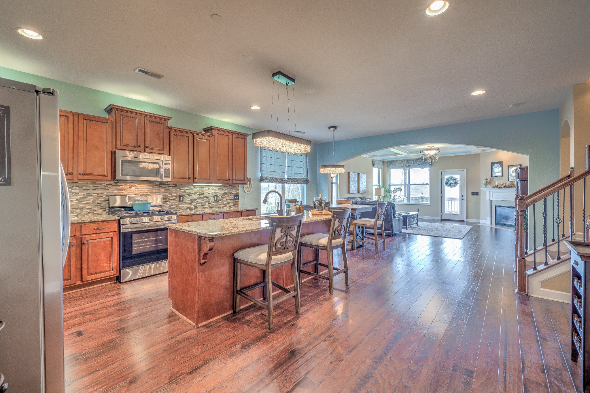 5048 Falling Water Road Nolensville, TN 37135 - Photo 10 of 40 a kitchen with stainless steel appliances granite countertop wooden floors stove top oven with cabinets and wooden floor