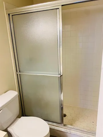 a bathroom with a glass shower door
