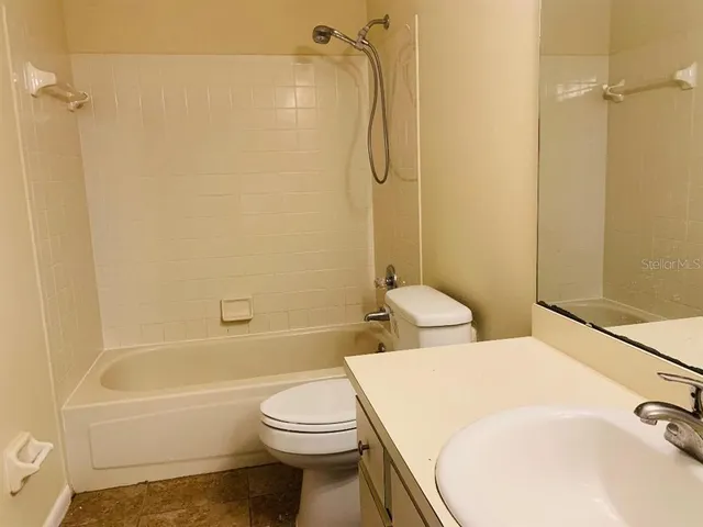 a bathroom with a toilet and a bathtub