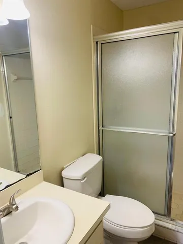 a white toilet sitting next to a bathroom sink
