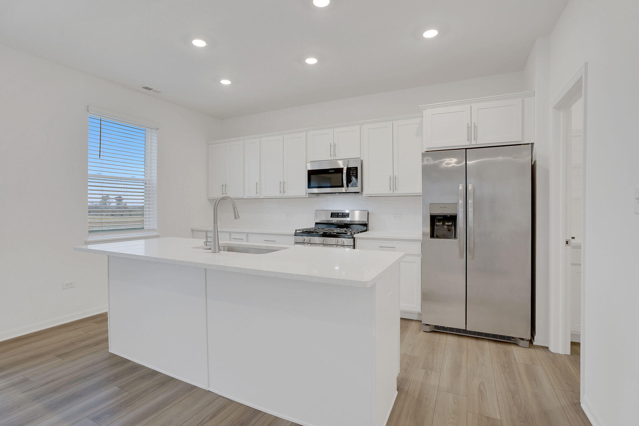 521 East 127th Place Crown Point, IN 46307 - Photo 13 of 37 a kitchen with a refrigerator a sink and a microwave