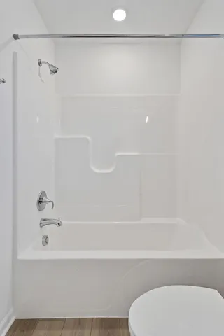 a bathroom with a shower and a toilet