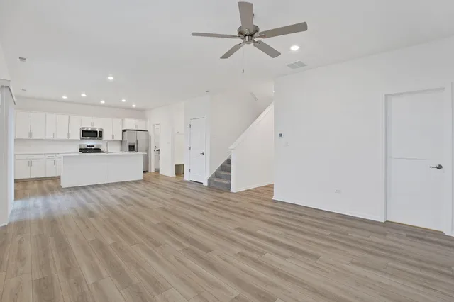 a view of a kitchen with a sink and a refrigerator