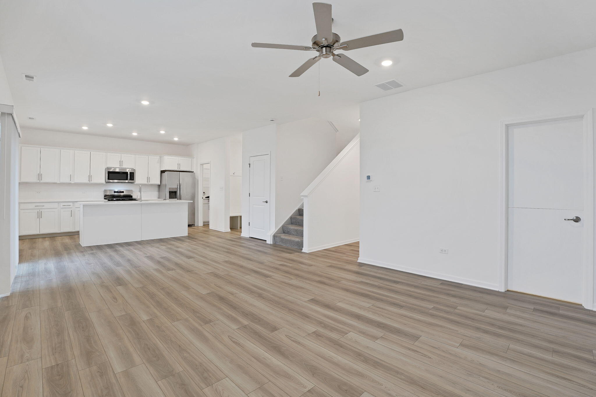 521 East 127th Place Crown Point, IN 46307 - Photo 7 of 37 a view of a kitchen with a sink and a refrigerator