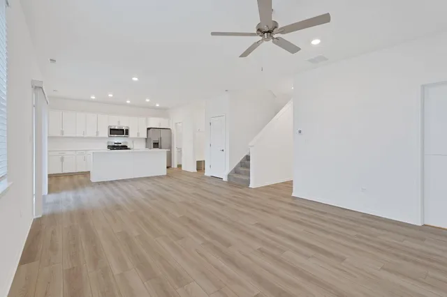 a view of a kitchen with a sink and a refrigerator