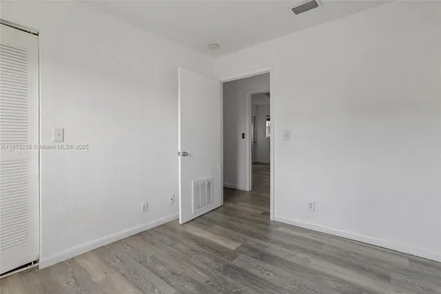 a view of a room with wooden floor