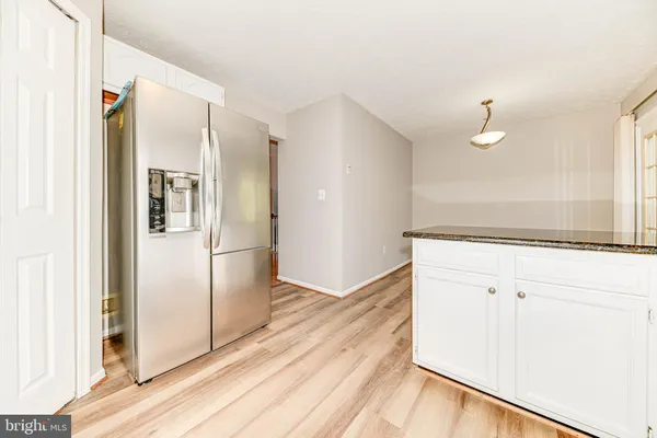 a view of a kitchen with a sink and refrigerator
