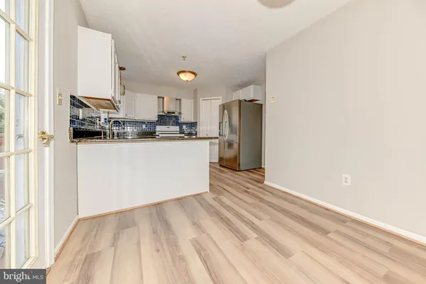 a kitchen with stainless steel appliances a refrigerator and a stove