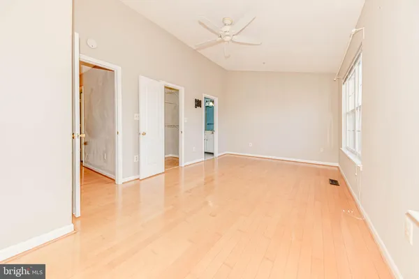 a view of an empty room with wooden floor