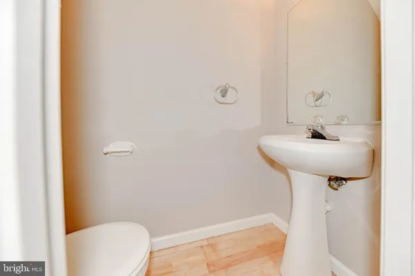 a bathroom with a sink a toilet and mirror