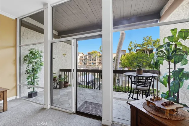 a view of a porch with potted plants