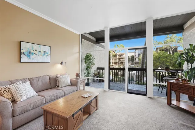 a living room with furniture a flat screen tv and floor to ceiling window