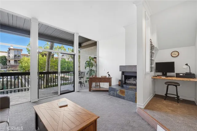 a workspace with furniture and floor to ceiling window