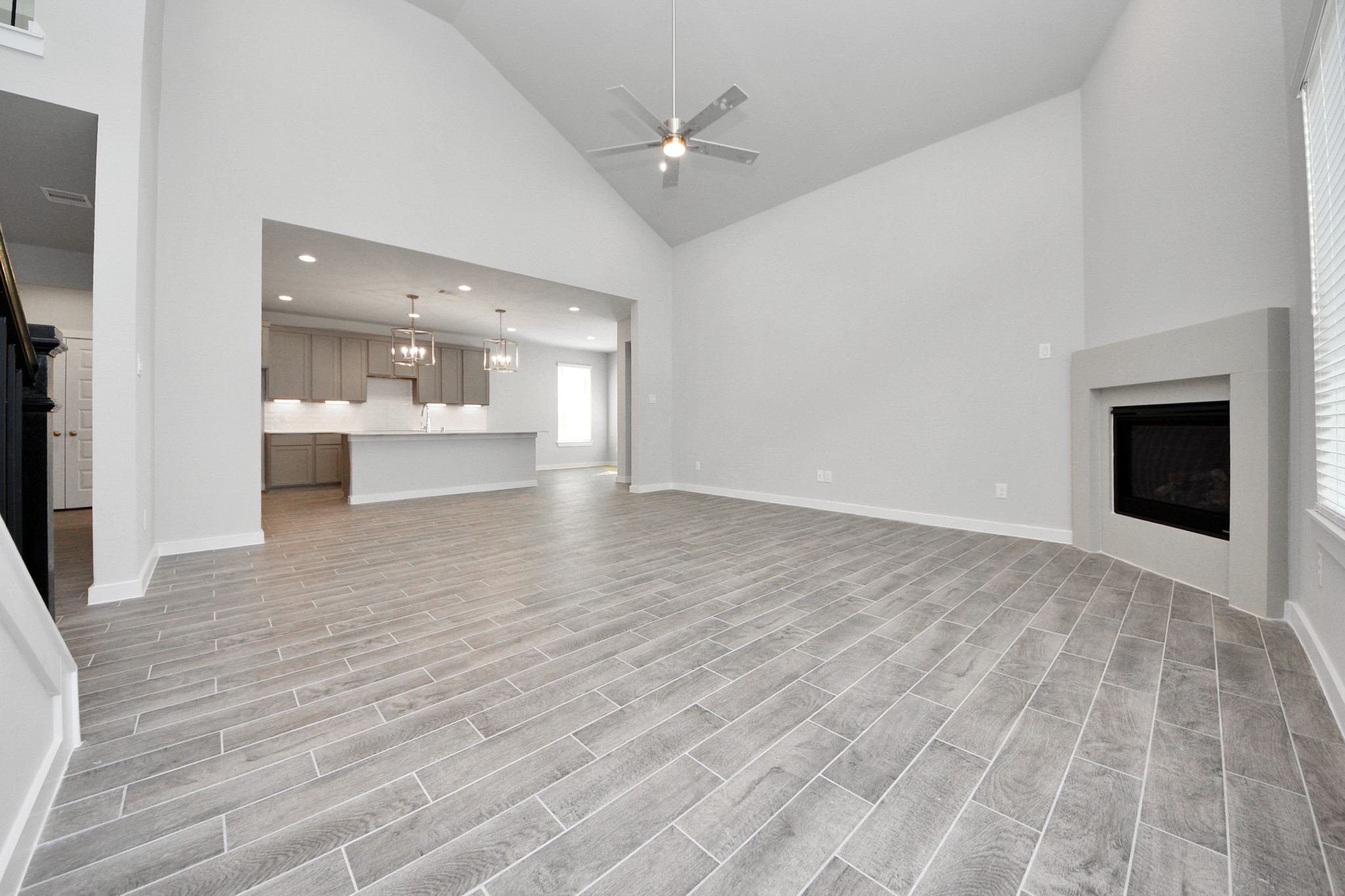 3002 Bury Park Dr Spring Spring, TX 77373 - Photo 13 of 45 Gather the family and guests together in your lovely living room! Featuring soaring high ceilings, recessed lighting, ceiling fan, custom paint, gorgeous floors, and large windows that provide plenty of natural lighting throughout the day.
