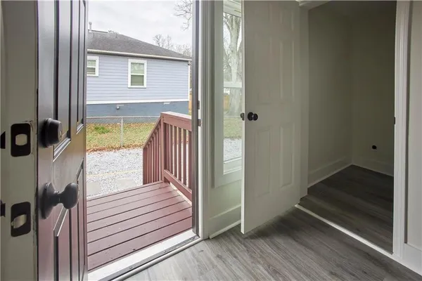 a view of a balcony with wooden floor and a window