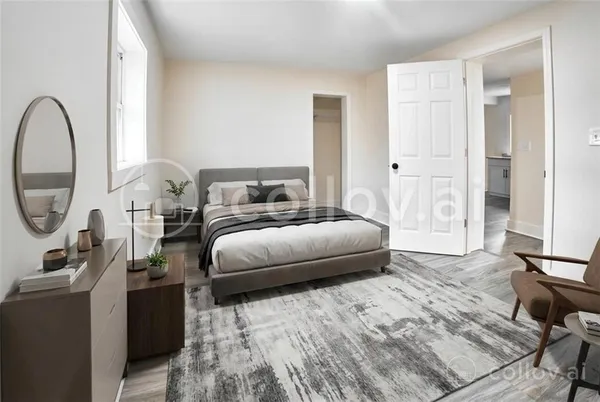 a bedroom with a bed a mirror and a window