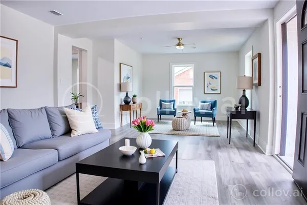 a living room with furniture and wooden floor